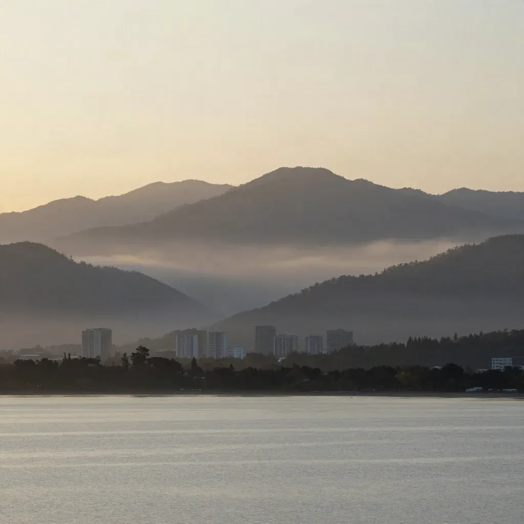 Hazy North Shore mountains over downtown and inlet water at blue hour